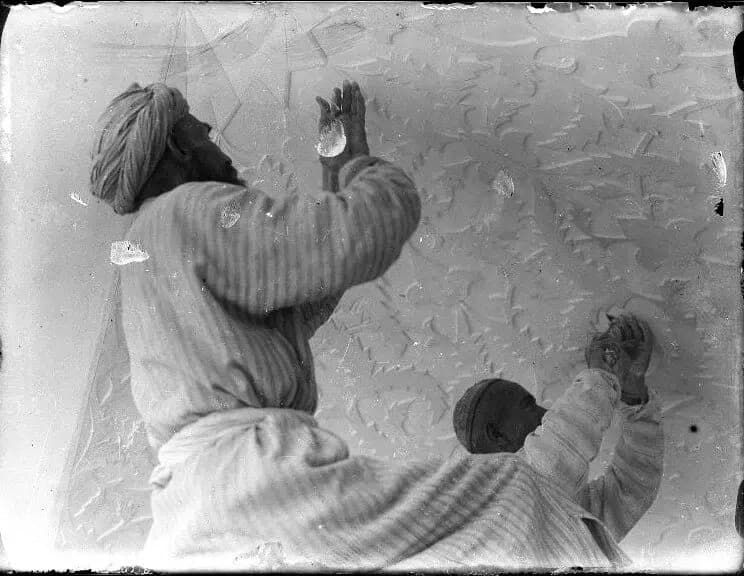 Master carvers restoring the ornamentation on a vaults in the Abdulaziz Khan Madrasa, 1927. 