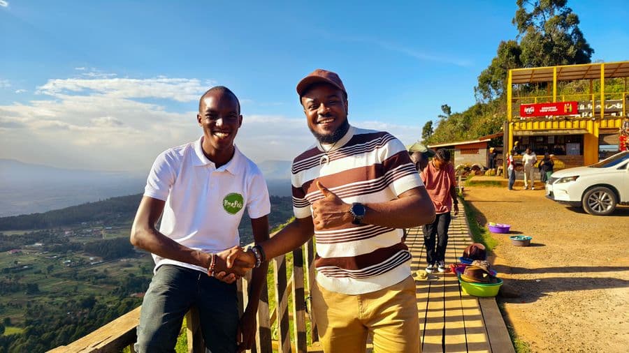 Two young men holding hands and smiling 
